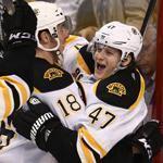 Reilly Smith (18) hugs teammate Torey Krug after Krug broke a 1-1 tie against the Panthers in the third period.