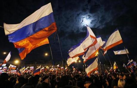 People held Russian flags as they celebrated in Lenin Square after the end of the referendum in Simferopol, Crimea, Ukraine.
