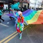 Kia Dumas, of Stoughton, was welcomed to jump in and help carry the rainbow flag with members of Boston Pride.