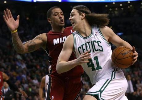 Kelly Olynyk drve past Heat forward Michael Beasley en route to a layup in the first half. 
