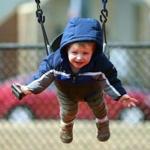 On the first day of spring, the Joe Moakley Park was empty except for Brady Laine of South Boston who got a push on a swing from his mother.