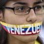 An antigovernment demonstrator stood with a ribbon covering her mouth during a protest in front of an office of the Organization of American States in Caracas.