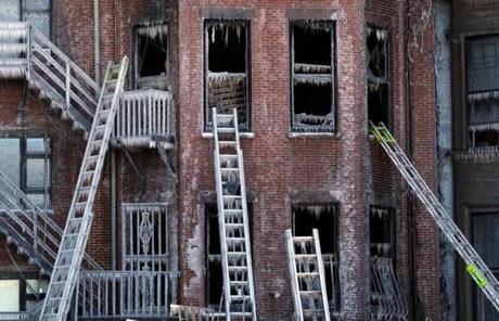Ladders rested against windows covered in ice at the scene of Wednesday's nine-alarm fire on Beacon Street in the Back Bay.

