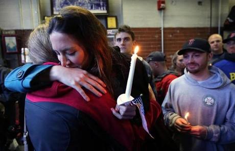Sarah Wessmann was hugged by a friend during the West Roxbury vigil on Friday.
