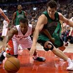 Raptors guard Kyle Lowry and Celtics forward Kris Humphries scrambled for a loose ball during the first half.