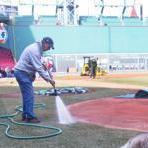 David Mellor (right) and his crew always dig deep to keep the Fenway grass pristine. Stan Grossfeld/Globe Staff