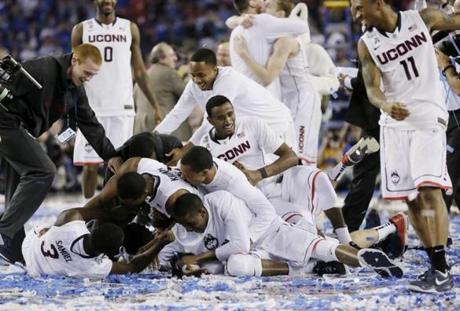 The UConn men’s basketball team celebrates after winning the NCAA championship game against Kentucky. 
