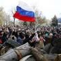 Protesters waved a Russian flag in front of the police headquarters in Slaviansk on Saturday.