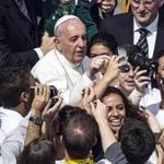 Pope Francis greeted people taking souvenir photos with him as he arrived to lead Palm Sunday Mass in Saint Peter’s Square.