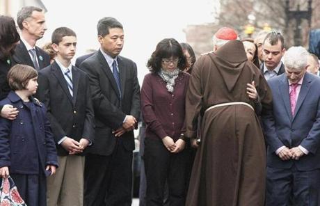 Cardinal O’Malley embraced the family members of Marathon bombing victims.
