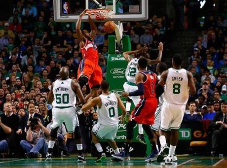 The Wizards’ Trevor Booker dunks over a crowd of hapless Celtics defenders. 


 (Photo by Jared Wickerham/Getty Images)
