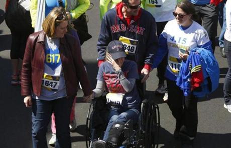 Rebekah Gregory DiMartino, a 2013 Boston Marathon bombing survivor, wiped her face after crossing the finish line.  
