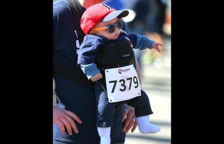 John Husson from Watertown carried his 5-month-old boy, Beau as he got set to start the race. 
