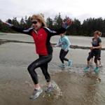 Runners on Mackenzie Beach at a ChiRunning retreat on Vancouver Island.