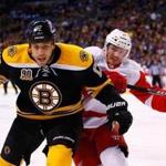 Bruins forward Milan Lucic, who was at the center of some controversy after his actions in Game 1, keeps Gustav Nyquist on his back during Sunday’s win.
