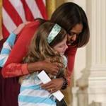 First lady Michelle Obama embraced Charlotte Bell, 10, while hosting a question-and-answer session with the children of Executive Office employees.