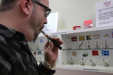 Steve Halligan, a pack-a-day smoker, tries out some sample flavors at Vape Daddy’s in Newton. At first skeptical, he left the store after buying two blends.
