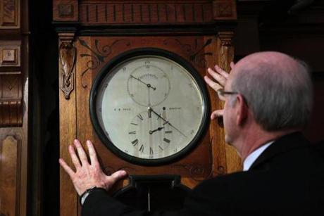  Michael Finn with a rare 19th-century clock at E.B. Horn Co.
