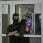 A pro-Russian masked man stood watch inside the Mariupol town hall in eastern Ukraine.