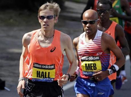 Ryan Hall, left,  runs near Meb Keflezighi. along the route.

