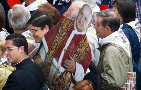 A cardboard cutout depicting Pope John XXIII was carried by a person attending Sunday’s canonization ceremony for John XXIII and Pope John Paul II.

