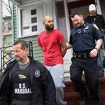 US Marshal Tim Orava and Boston police Officer Frank Sheridan removed Anton Febles from a Blue Hill Avenue apartment.