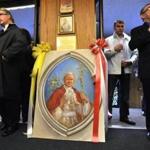 A portrait of Pope John Paul II stood by the entrance of Our Lady of Czestochowa in South Boston, as parishioners arrive for a Polish language mass celebrating the canonization of John Paul II. 