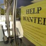 A help wanted sign on the door of a gas station in Encinitas, Calif.