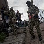 Pro-Russians stood guard at a barricade near the railway in Andreevka, a few kilometers south of Slovyansk, Ukraine, on Sunday.