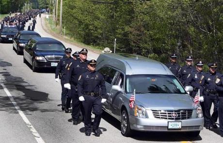 A hearse carrying the body of Officer Steve Arkell made its way to a memorial service. 
