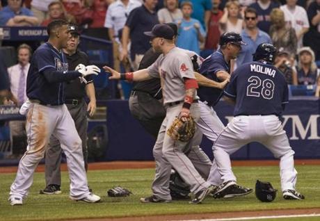Red Sox first baseman Mike Carp (center) confronts the Rays' Yunel Escobar during a seventh-inning brawl. Steve Nesius/Associated Press
