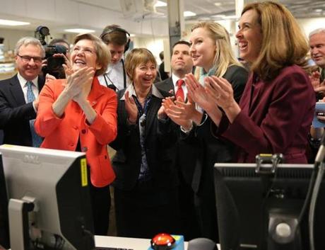 Senator Elizabeth Warren (left) joined joyous researchers celebrating the restart of a nuclear fusion project at MIT. 
