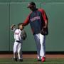 Red Sox pitcher Felix Doubront and his son enjoy some time on the field at Fenway Park prior to a recent game against the Tampa Bay Rays.