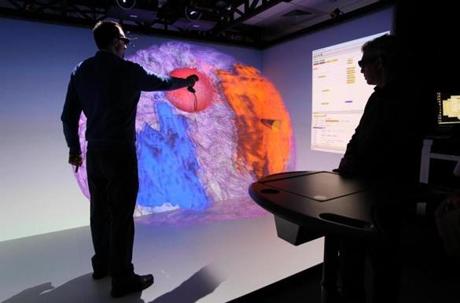 Pfizer chemist Kevin Hallock rotated a 3-D image of a human brain projected on a giant screen.
