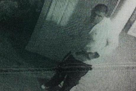 Surveillance photos appear to show former Patriots star Aaron Hernandez holding a pistol.
