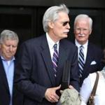 Robert A. Mulligan left the federal courthouse at the lunch break Tuesday. The former head of the state Trial Court system is a pivotal witness in the public corruption trial of former Probation Department officials.