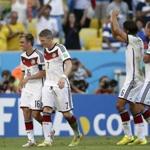 Germany's Philipp Lahm (16) and  Bastian Schweinsteiger (7) lead the celebrations after they halped dispatch France.