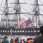 Spectators on Castle Island waved flags, snapped photos and cheered as the USS Constitution made her annual turnaround cruise in Boston Harbor for the last time for the next three years. 