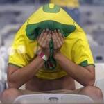 A Brazil fan covers his face after Germany?s 7-1 victory in their World Cup semifinal. (Frank Augstein/Associated Press)
