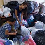 Volunteers with the Cambodian Mutual Assistance Association sorted donations.