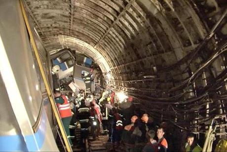 Rescuers working near a derailed subway train in a tunnel between Park Pobedy and Slavyansky Bulvar stations in Moscow.
