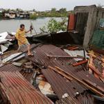 A Filipino resident removed debris after a typhoon hit the town of Kawit south of Manila.