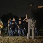A group of immigrants from Honduras and El Salvador who crossed the U.S.-Mexico border illegally are stopped, Wednesday, June 25, 2014, in Granjeno, Texas. At least six local, state and federal law enforcement agencies patrol the five mile zone which is illegal immigration?s busiest corridor. (AP Photo/Eric Gay)