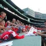 Liverpool F.C. midfielder Philippe Coutinho signs autographs for fans after team practice at Fenway Park.  
