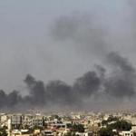 Smoke filled the sky above Benghazi, Libya, after clashes of militants, ex-rebel fighters, and government forces Saturday. Americans were urged to leave Libya immediately.
