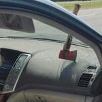 The axe that flew from the dump truck was seen in the windshielf of a car.