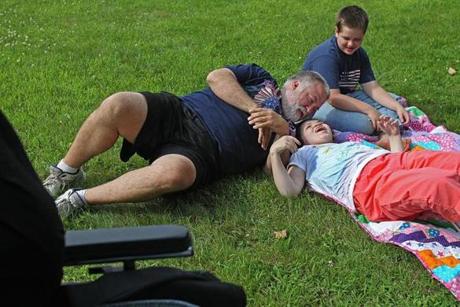 Haleigh played on the front lawn with her adoptive father, Keith Arnett, and brother, Jacob. The Arnetts first took Haleigh in as a foster child.
