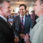 Retired General Stanley McChrystal spoke with Mark O?Donald, right, at an event for Seth Moulton, center. 