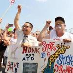 Kevin Wong, a bagger in Tewksbury, and John Connor, a customer, attended a rally Tuesday.
