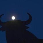 The moon appeared behind a bull in Spain Saturday night. The supermoon will officially become full at 2:09 p.m. Sunday.